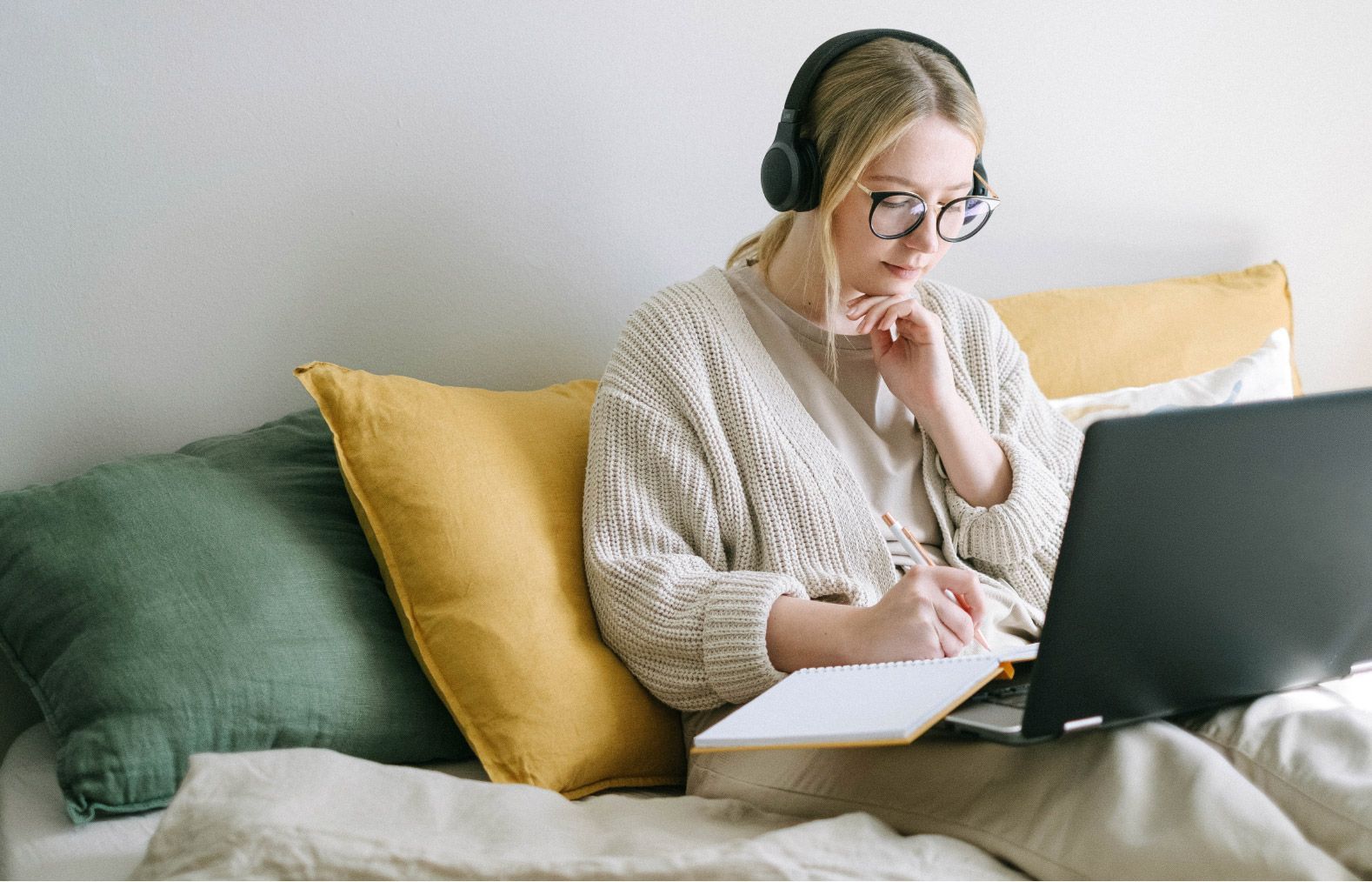 Woman with glasses sitting with laptop